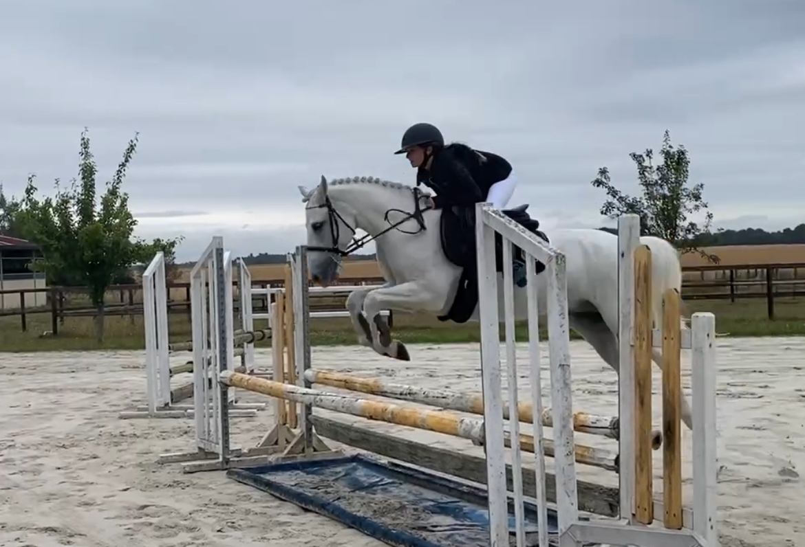 Charlotte Lobon glides over the jump on her new horse Louie with great confidence.