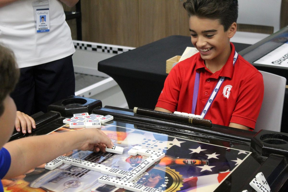 Students enjoy an exciting game of dominoes, a favorite in many Hispanic communities, bringing fun and friendly competition to campus.
