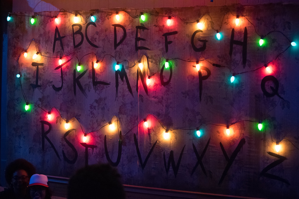 An alphabet wall lit with colorful Christmas lights, called the Communication Wall from Stranger Things.