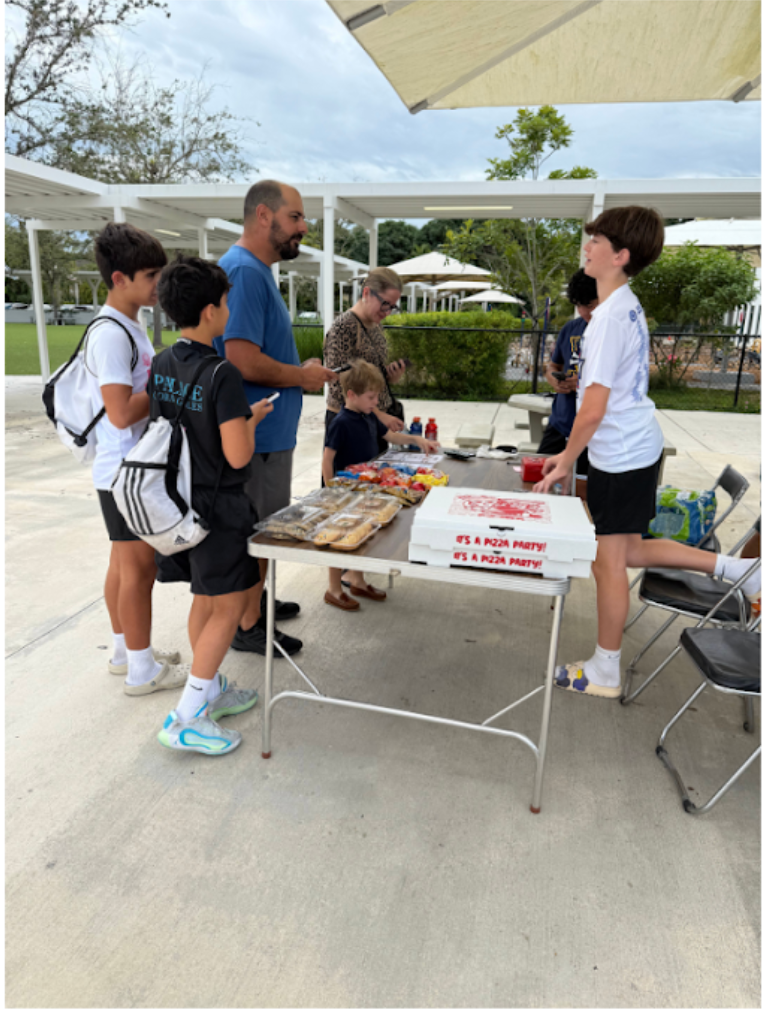 Eighth grader Asher Leinoff sells goods at his stand at Temple Beth Am.

