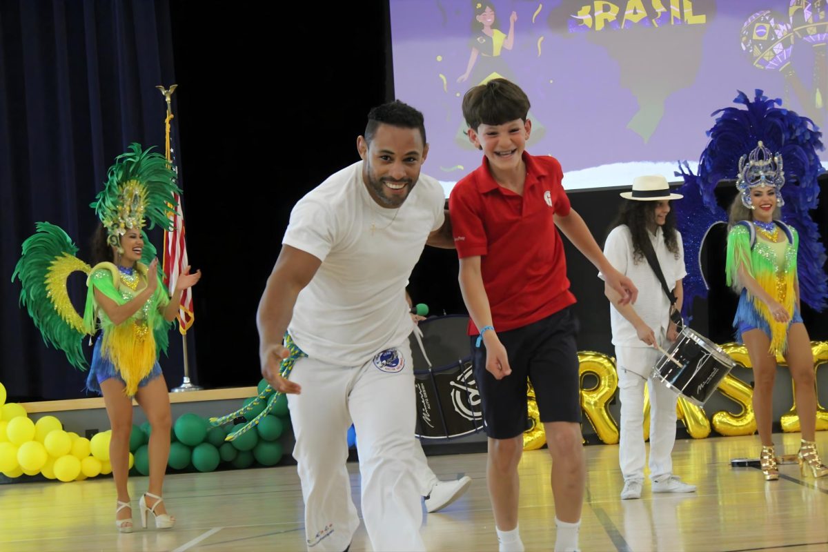 Seventh grader Steven Font danced with a capoeira performer, learning the Brazilian style and dancing through different acrobatic movements. 