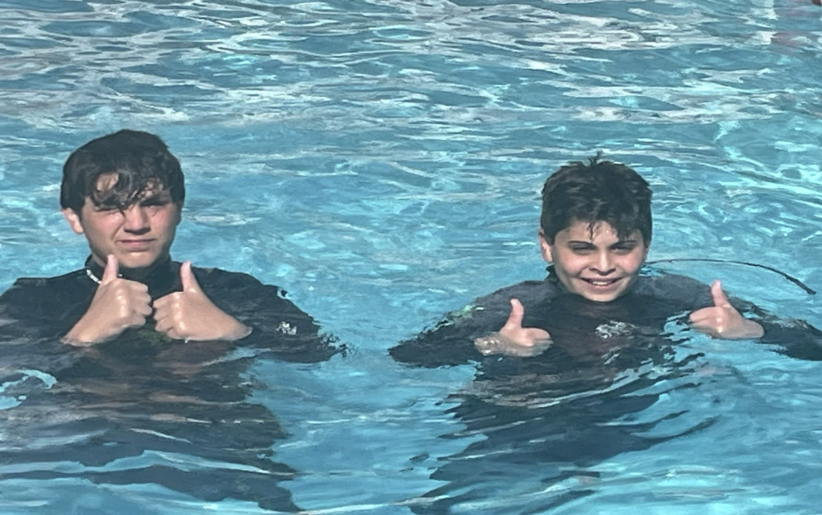 Eighth grader Gavin Havenick and his brother prepare to go scuba diving in the Bahamas.