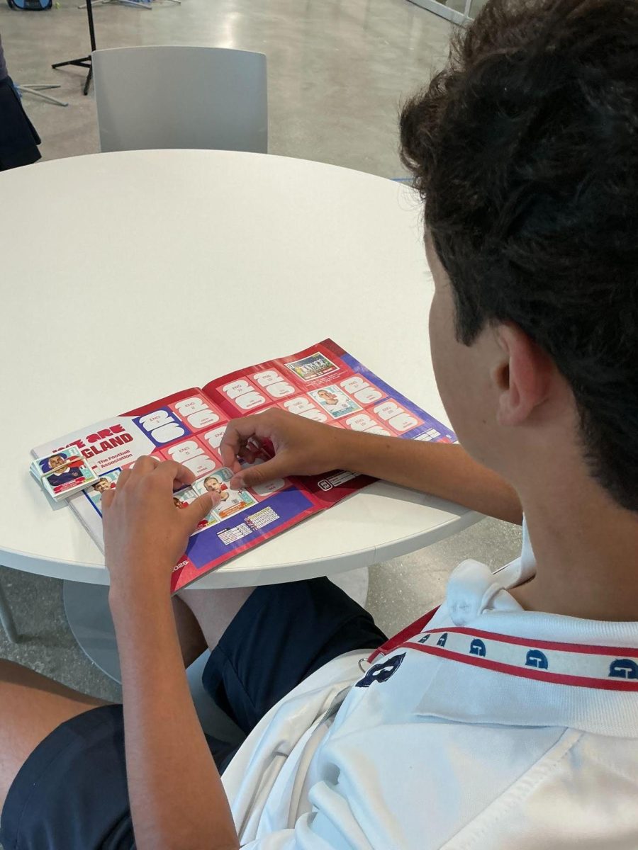 Eighth grader Sebastian Niño excitedly places the players stickers on his 2026 Fifa World Cup sticker album.